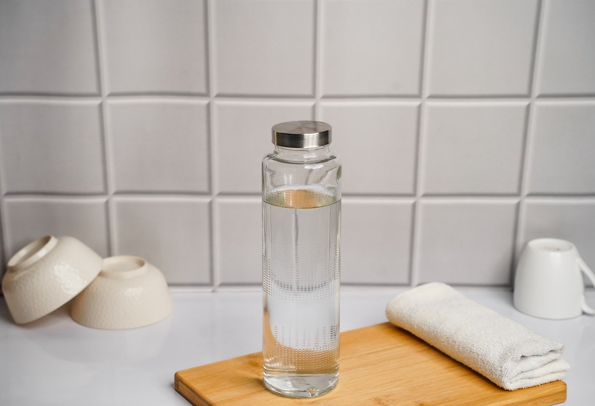 Glass water bottle with metal cap, eco-friendly and reusable for everyday hydration
